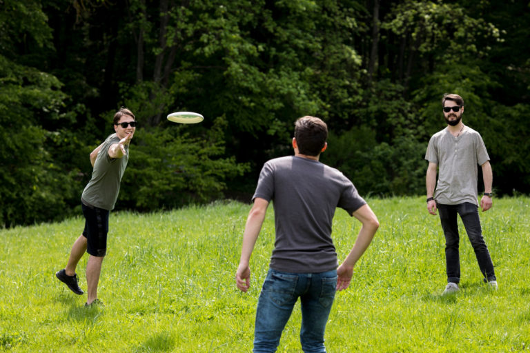 adult men playing frisbee